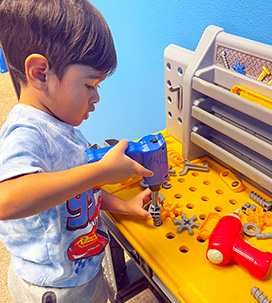 Boy playing with toy drill
